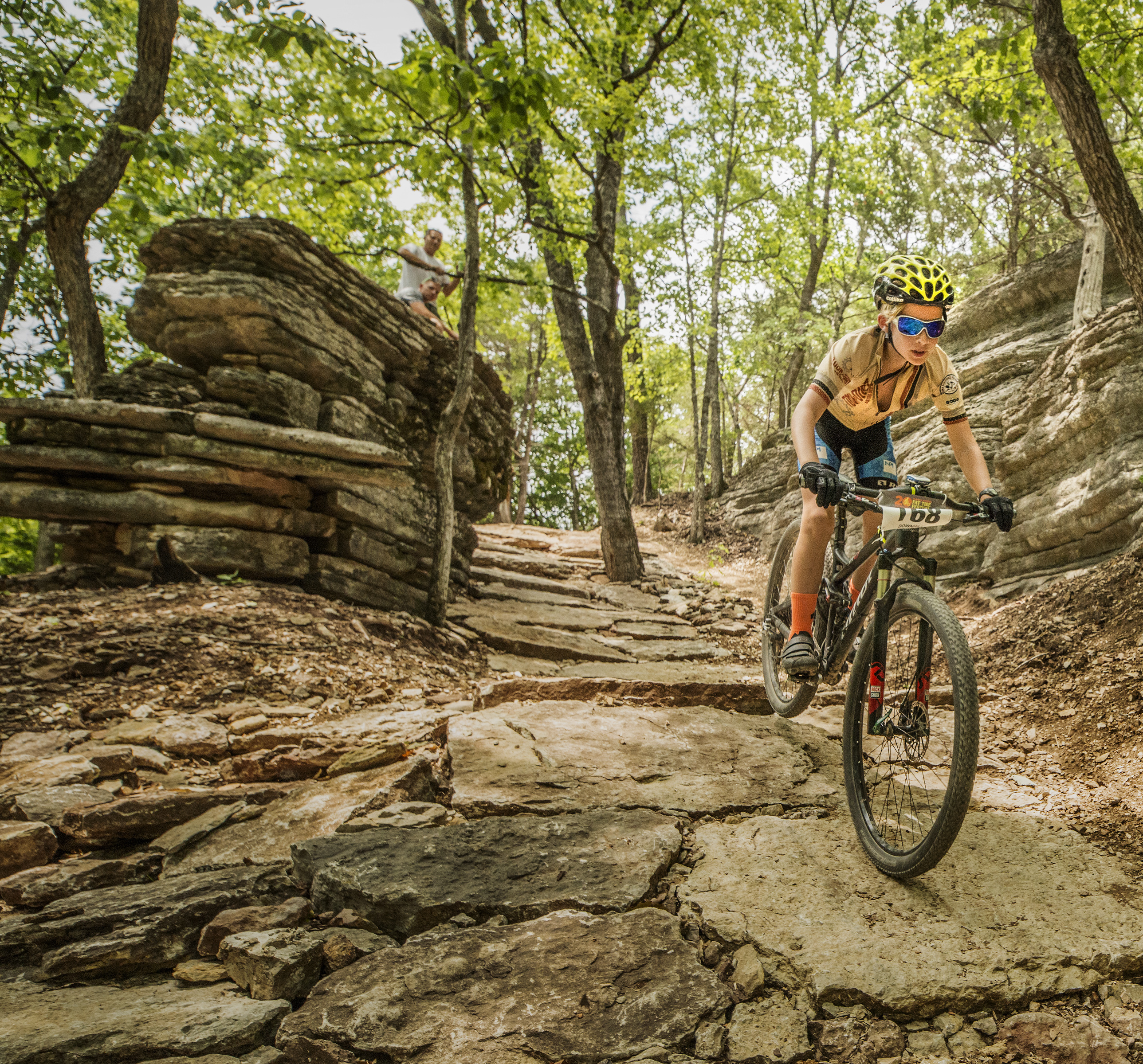 woman riding down a mountain bike trail
