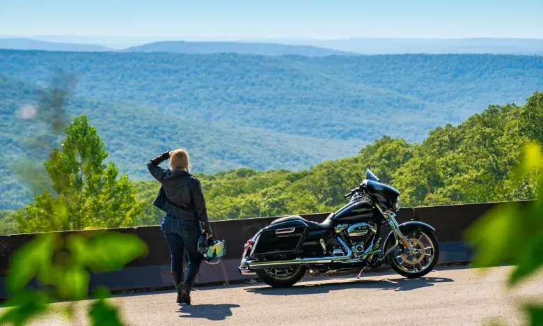 Scenic vista with woman and motorcycle