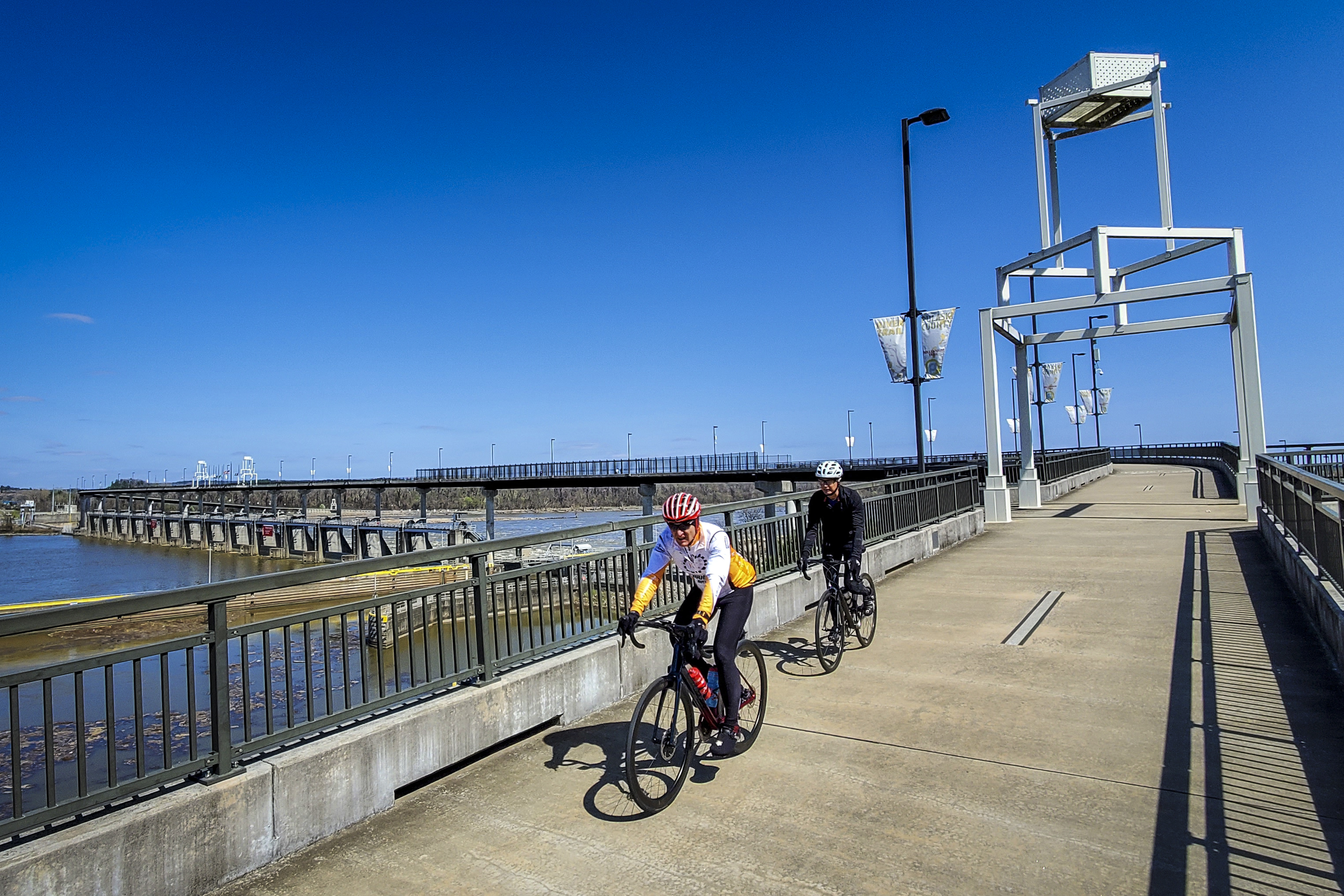 Two cyclists riding on the Big Dam Bridge