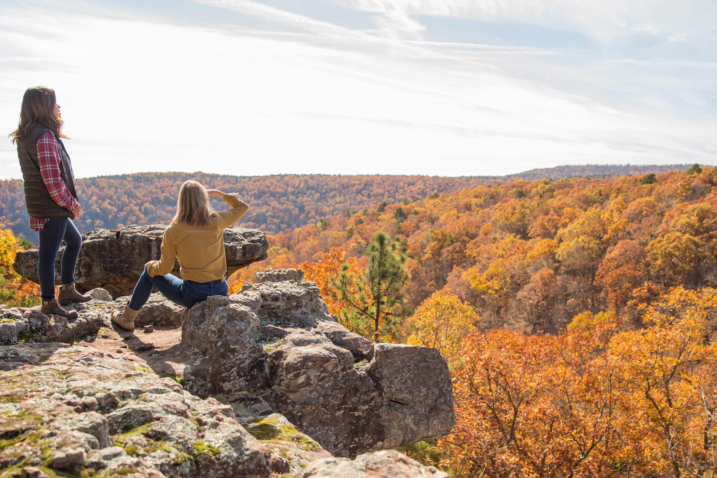Hikers looking out on a vista at the fall color
