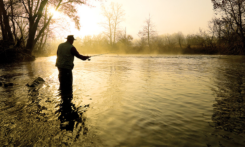 Man Fly fishing on river in Arkansas