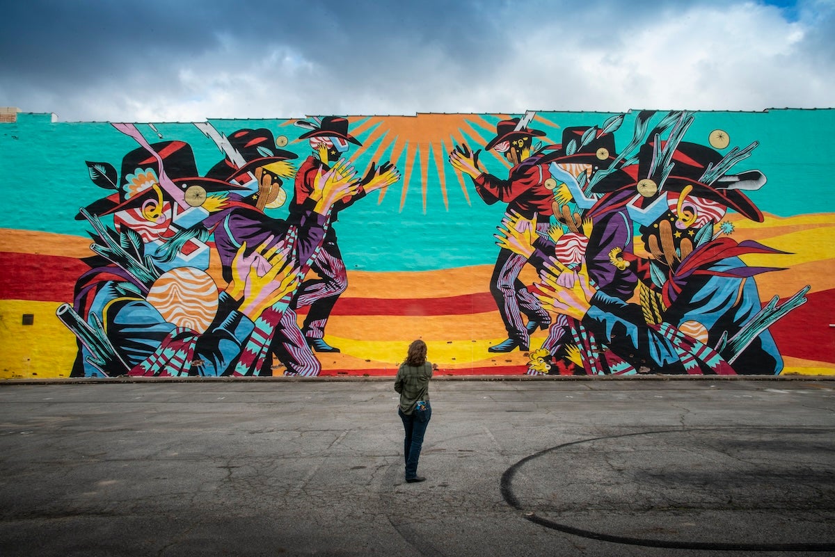 Colorful mural of cowboys