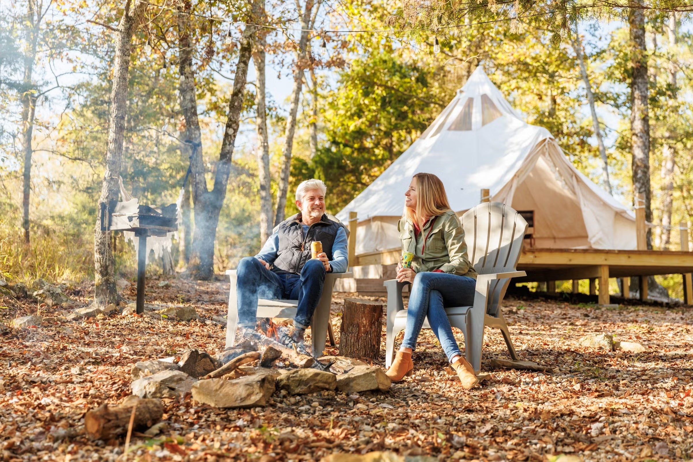 Couple sitting outside a tent at Ouachita Wilde