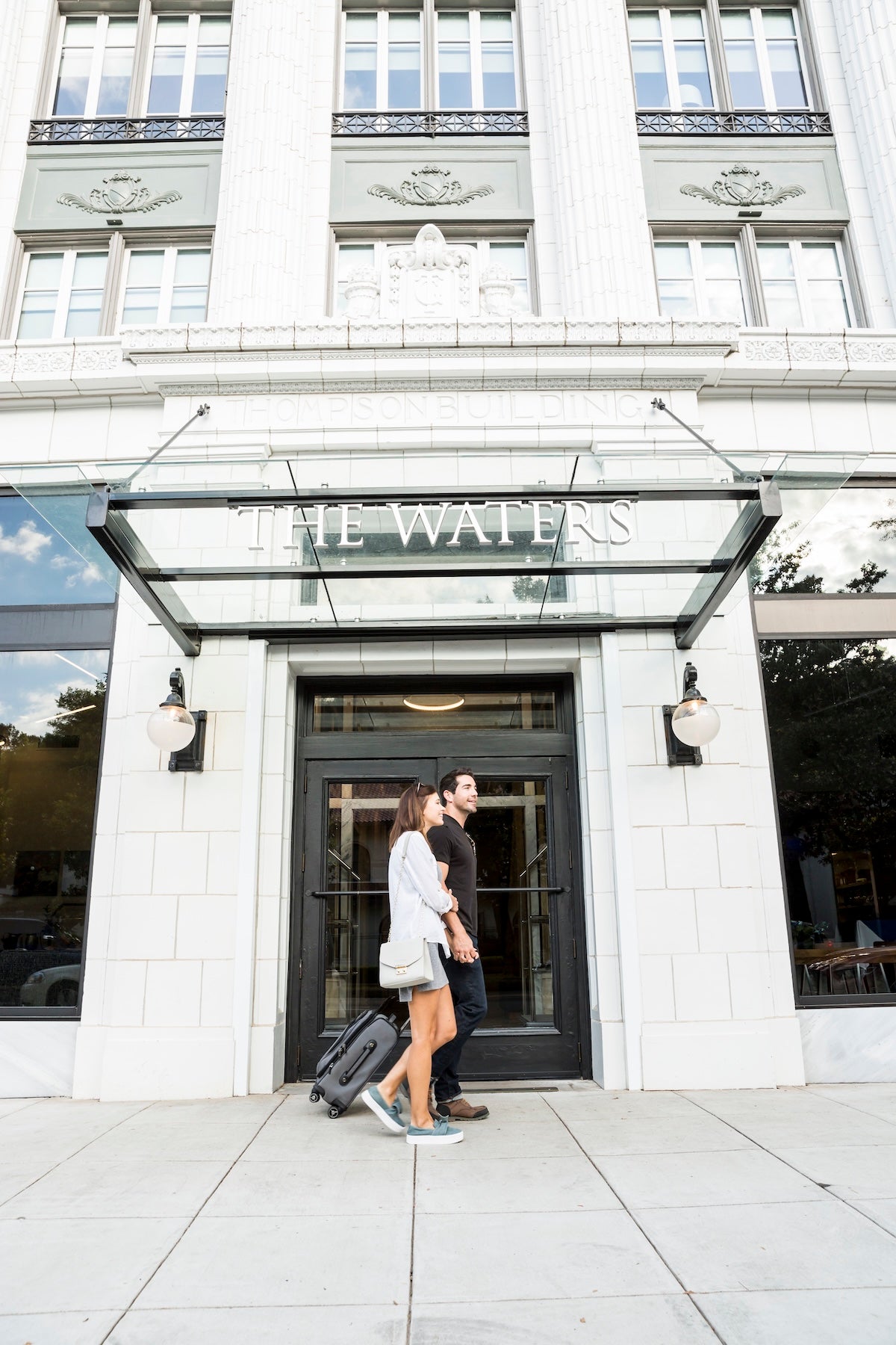 people walking on front of a hotel entrance