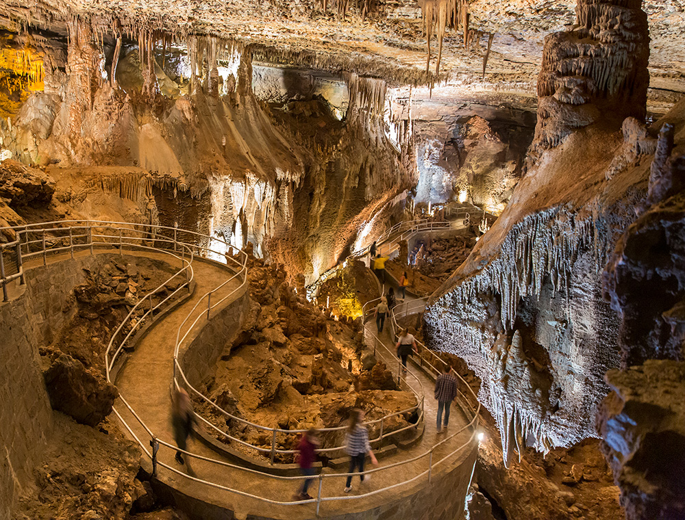 People walking on path in cave
