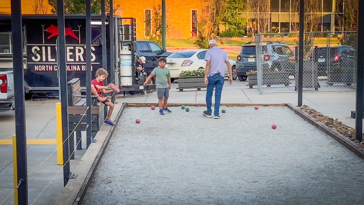 Family playing bocce ball