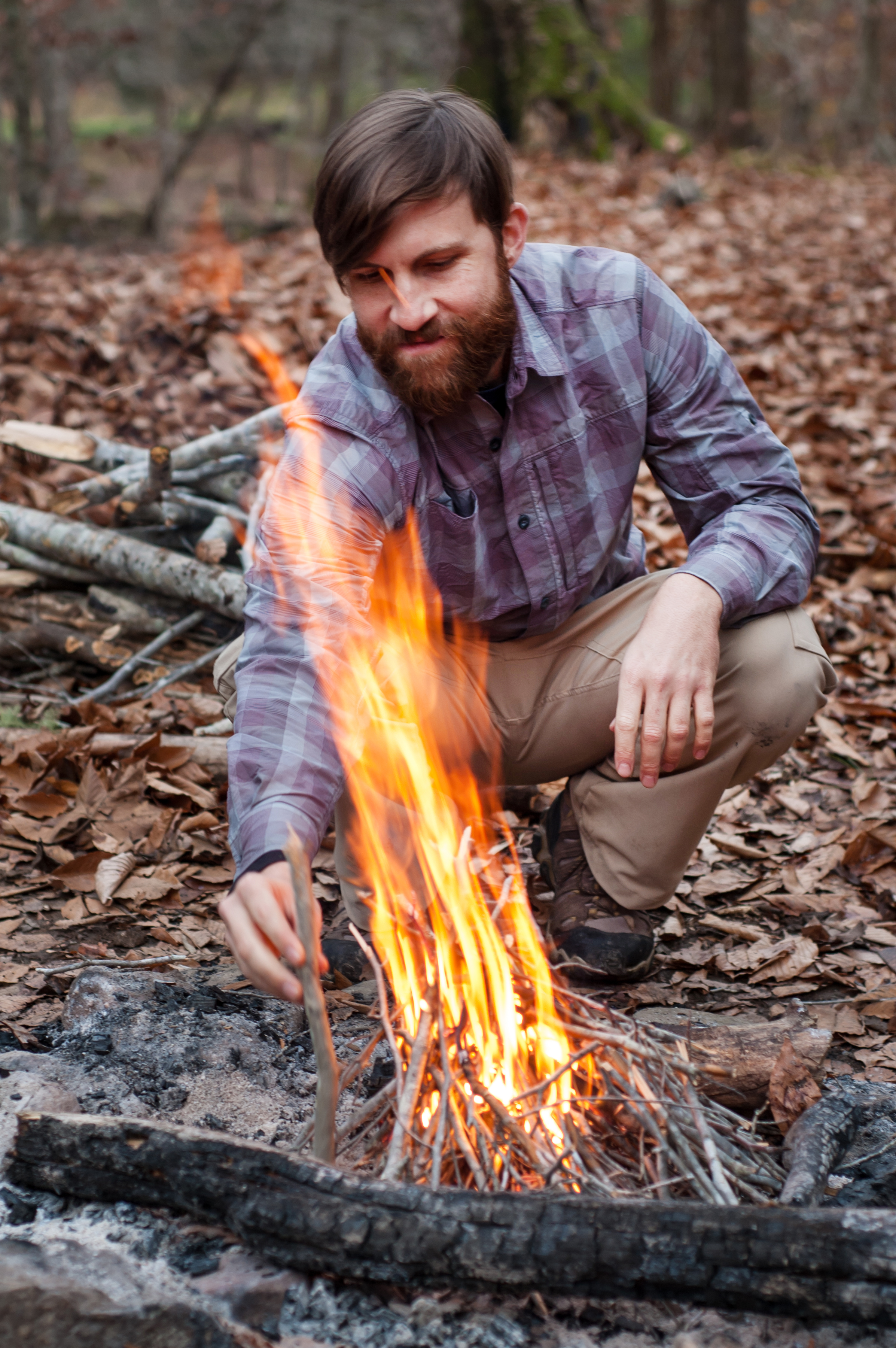 Camper building a fire on primitive campground along the Buffalo National River