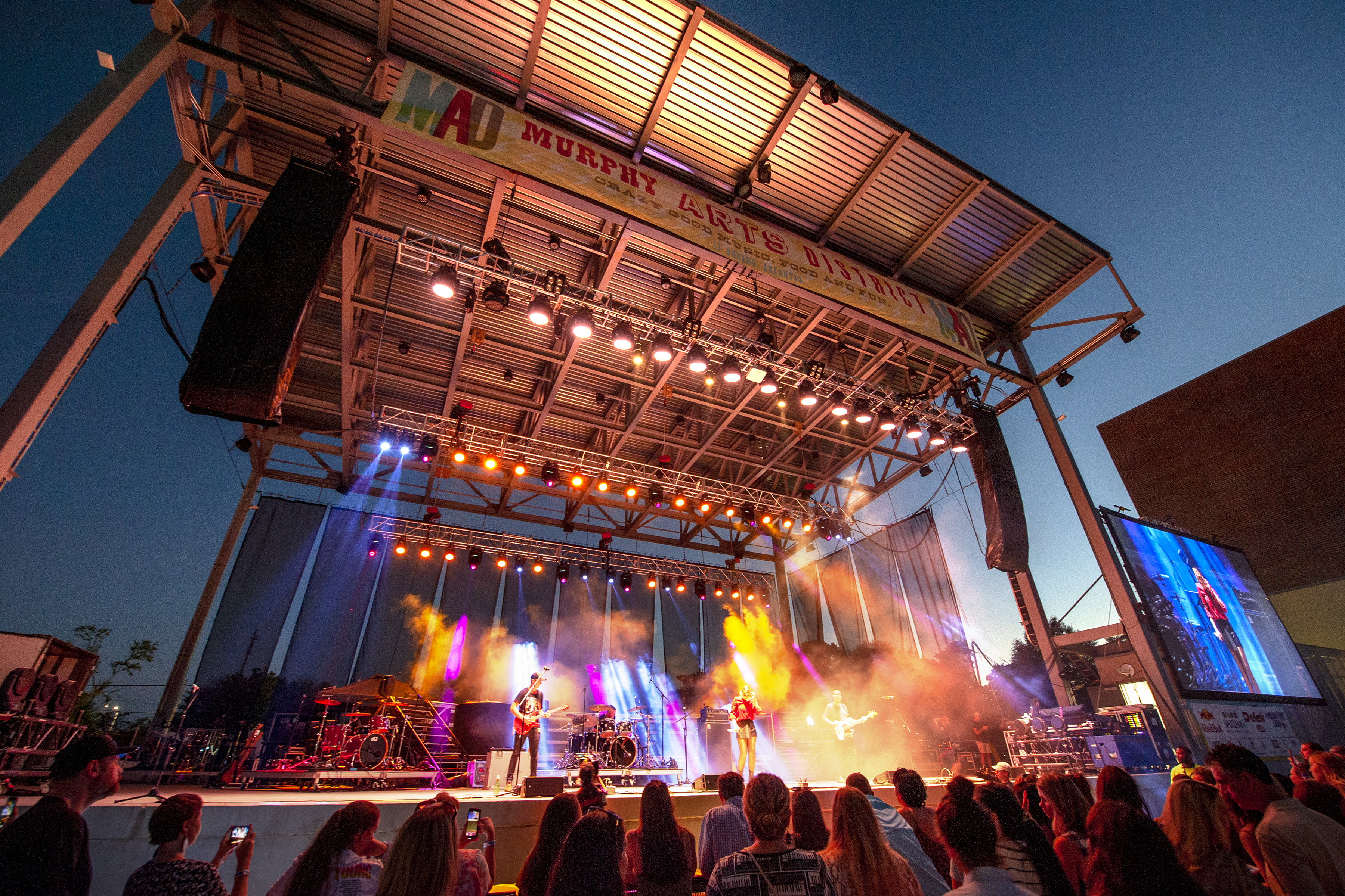 Artists perform on-stage to an audience at the MAD festival
