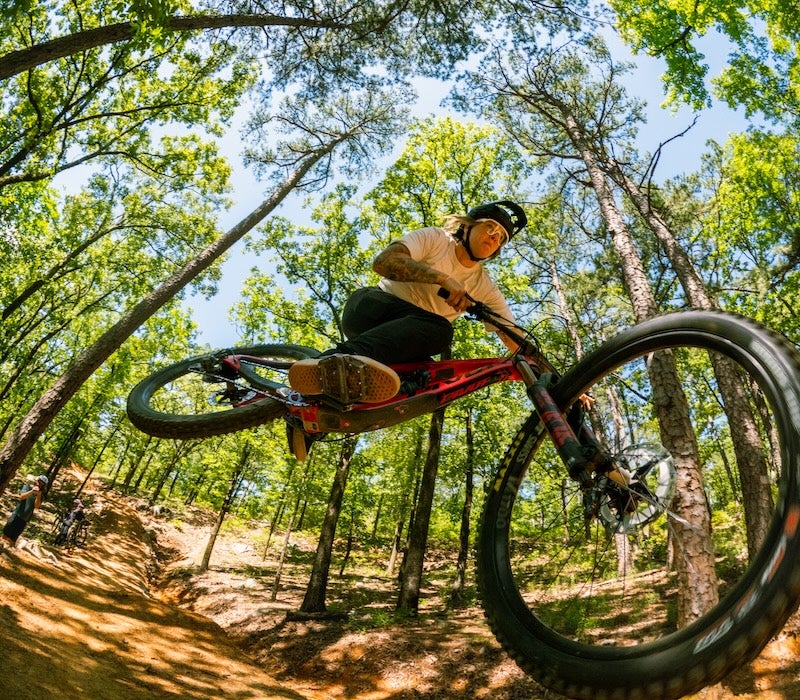 woman riding a bike at Pinnacle Mountain shot from underneath her bike