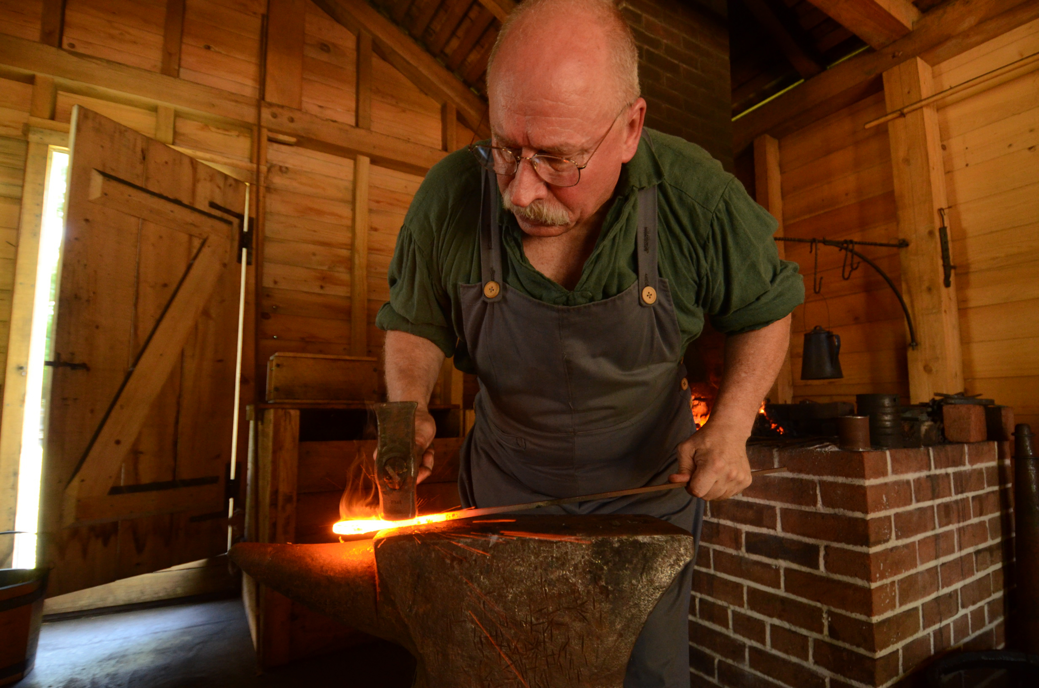 Artisan forging in the Blacksmith Shop at the Historic Washington State Park
