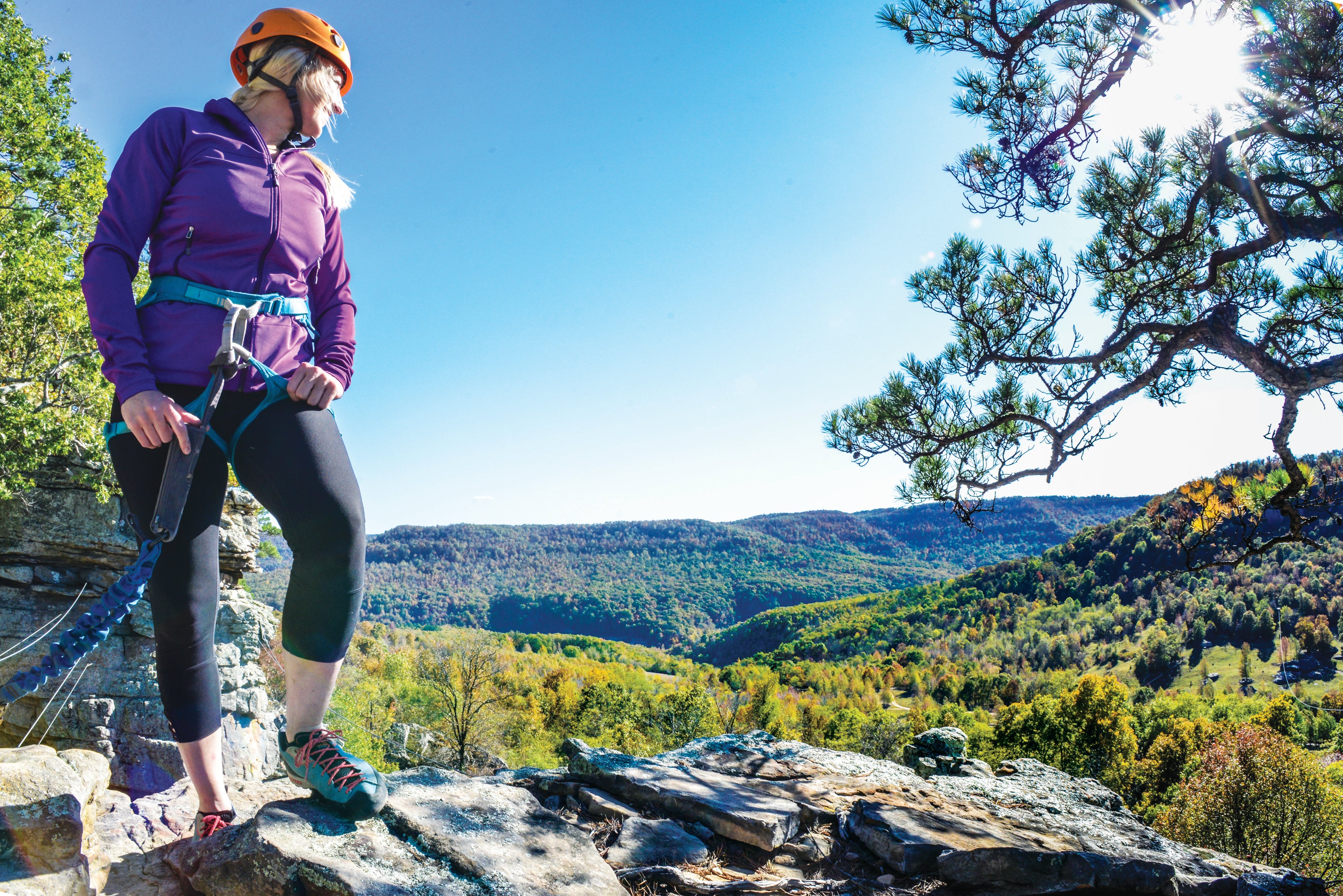 Woman rock climbing Horseshoe Canyon Ranch at Mount Magazine State Park