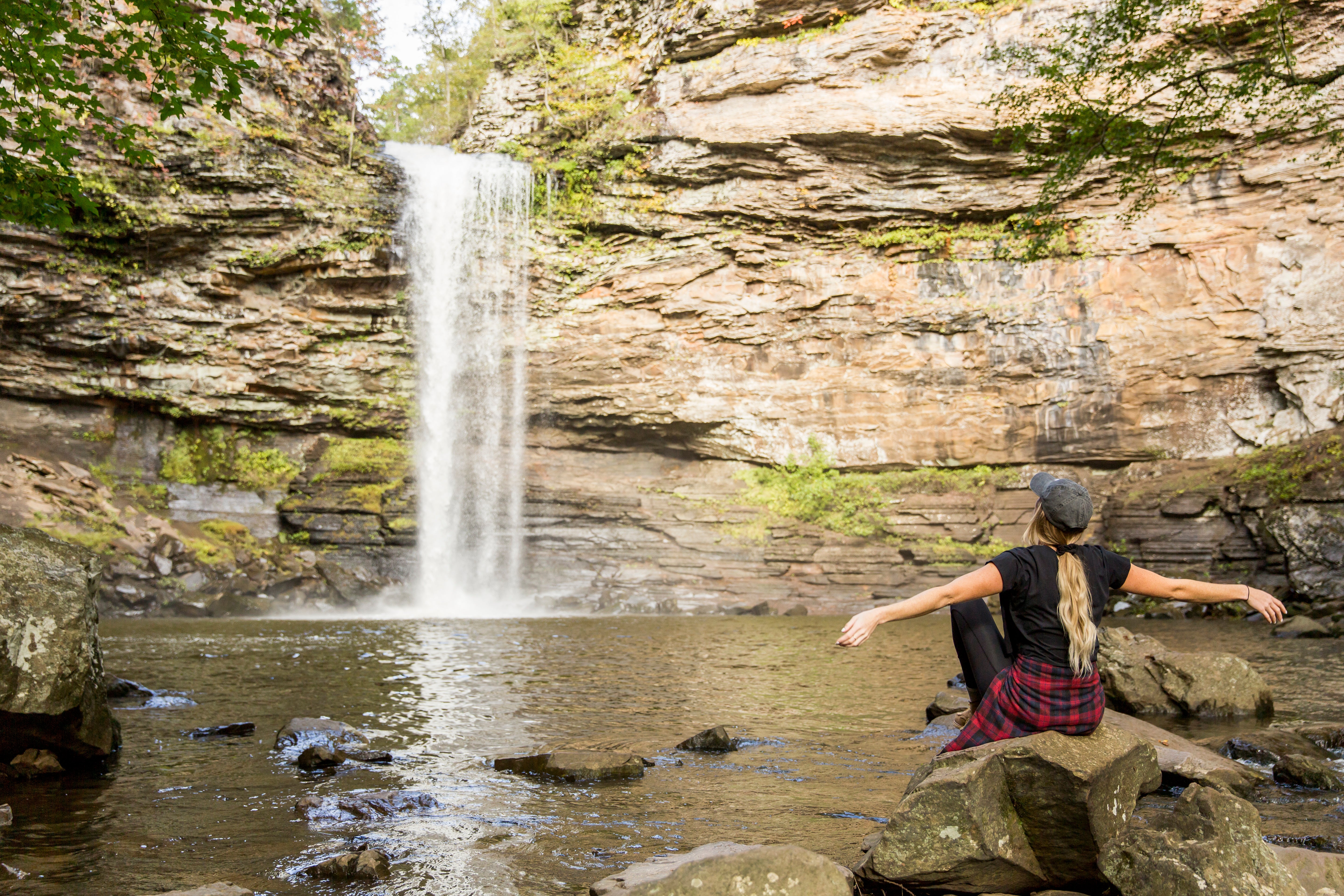 Woman watching waterfalls at Petit Jean State Park