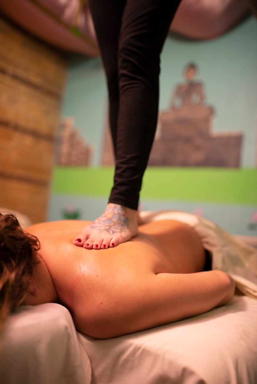 woman with foot on back for a massage