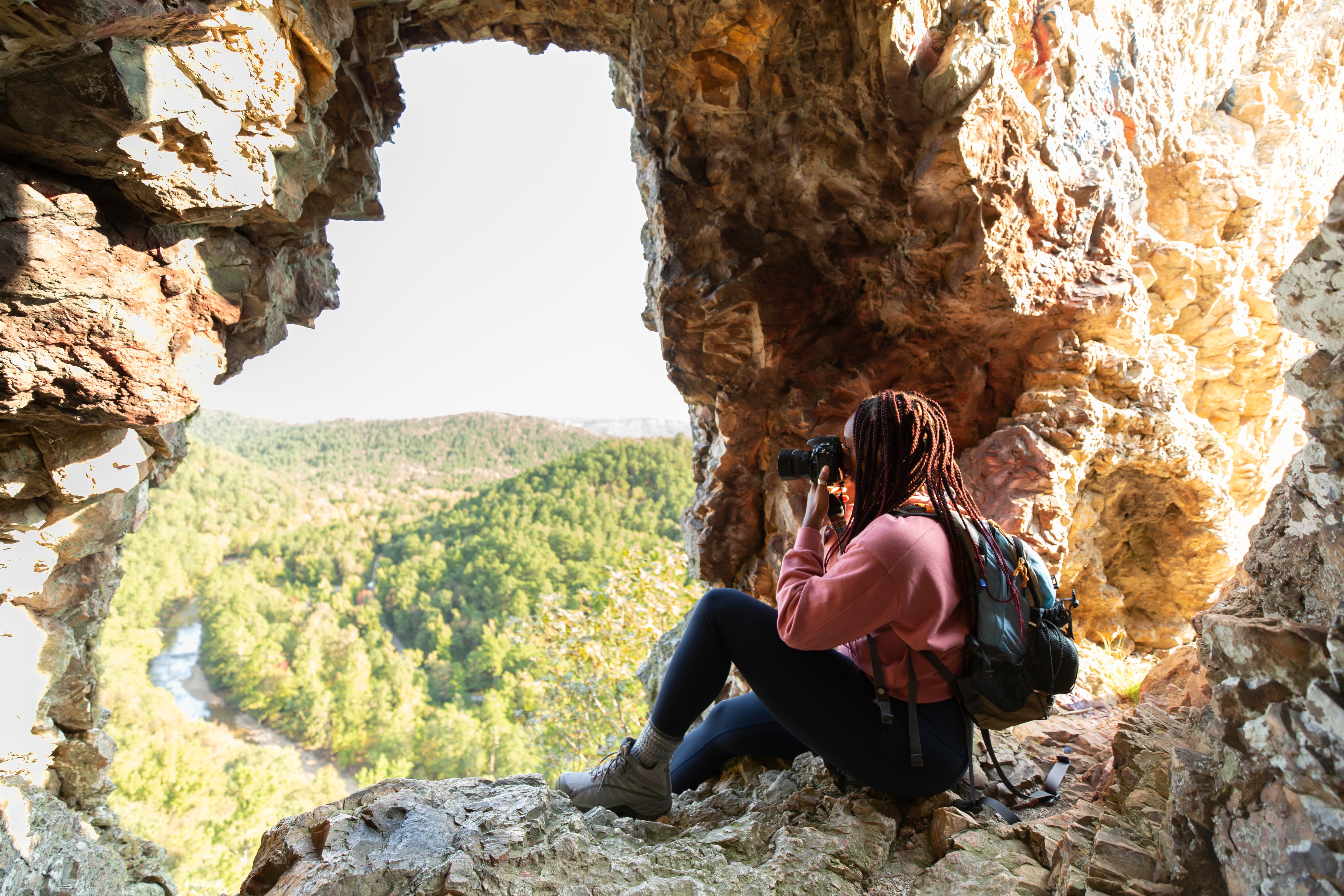 Woman stops to take photo on hike at Window Rock