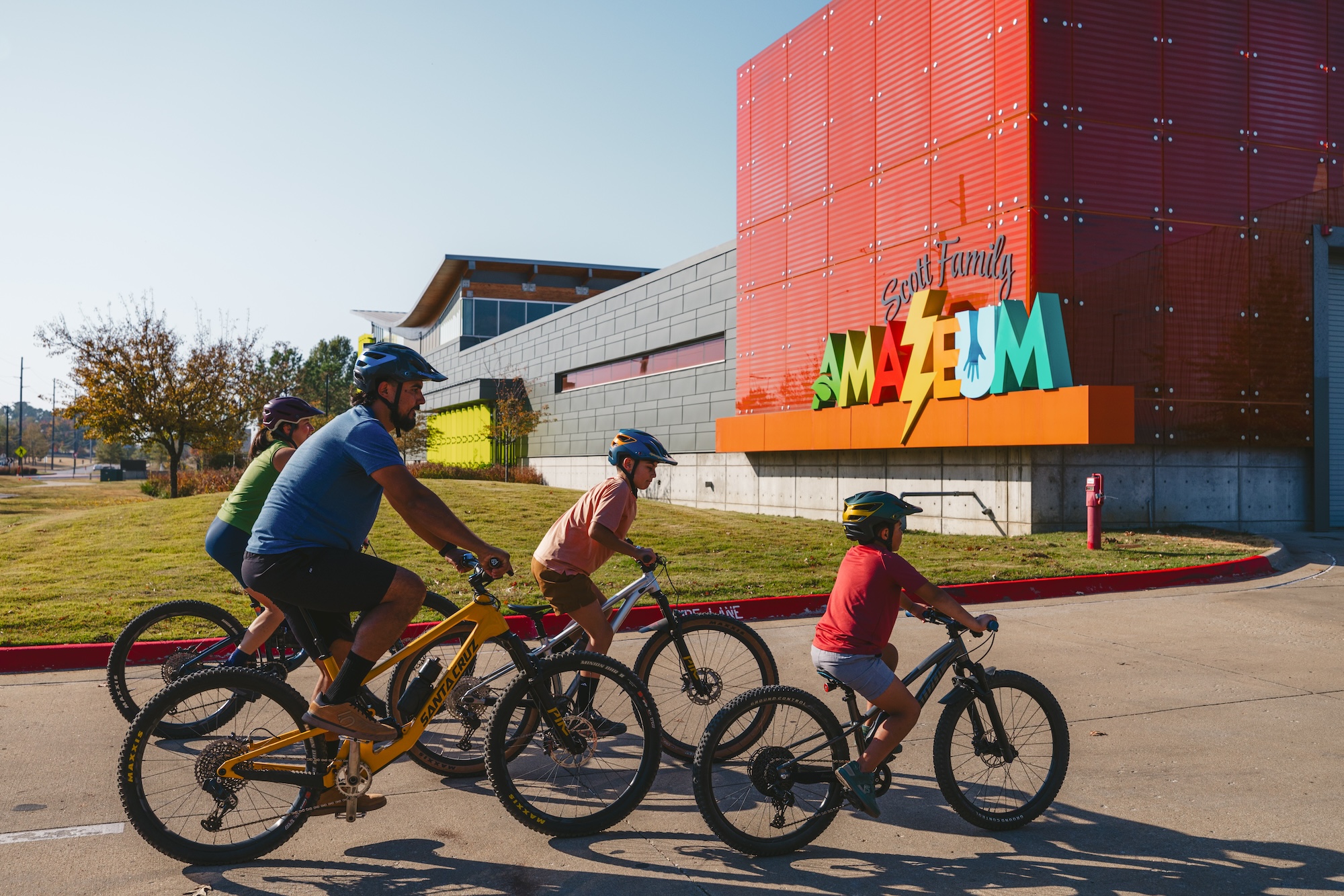 Family biking outside the Amazeum