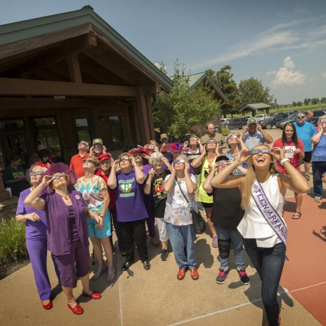 Group gathers outside with eclipses glasses to see the eclipse