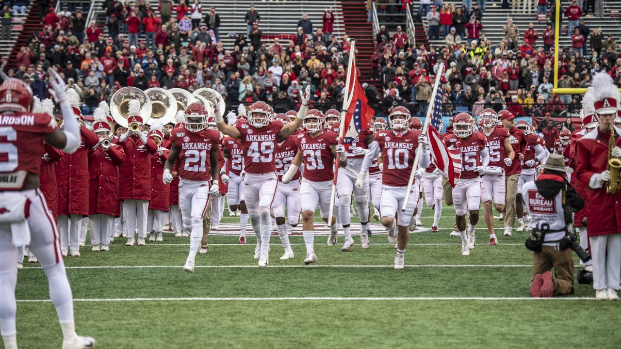 Razorbacks run out onto the field at War Memorial Stadium