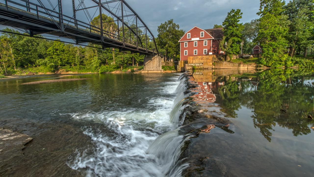 View of War Eagle Mill and Bridge from across the water