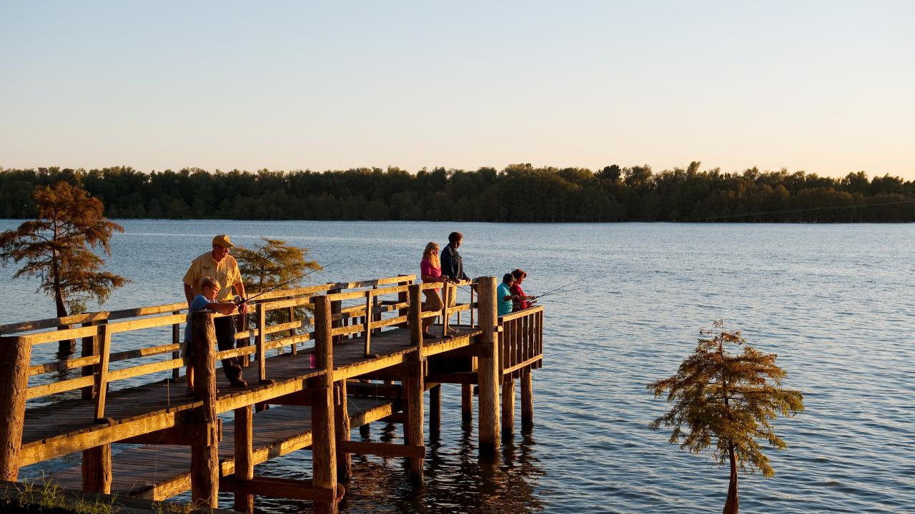 People fishing from a pier at Lake Chicot State Park