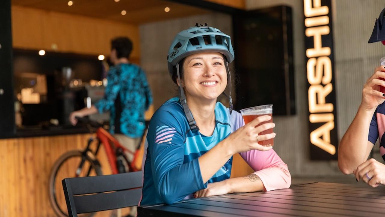 Biker enjoying a brew at Coler Mountain Bike Preserve in Bentonville