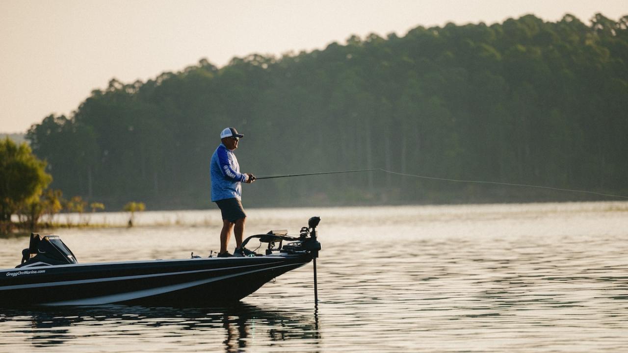 Man fishing at a lake on a boat