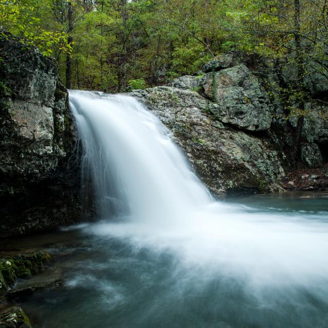 Falls Creek Falls cascading off a creekside at Lake Catherine State Park