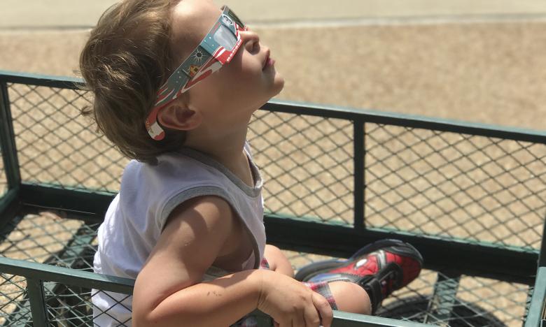 Child watching the 2017 Total Solar Eclipse with eclipse glasses
