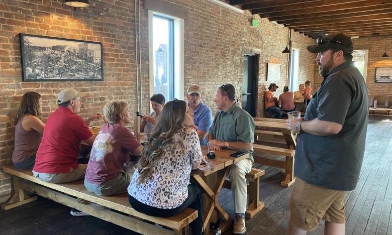 Kyle Swallows (standing) chats with upstairs diners at Rapp's Barren Brewing Company and Gastropub