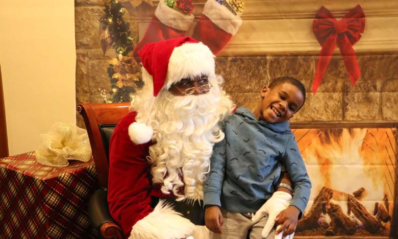 Young boy visits with Santa Claus at museum