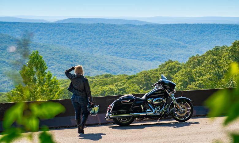 Scenic vista with woman and motorcycle