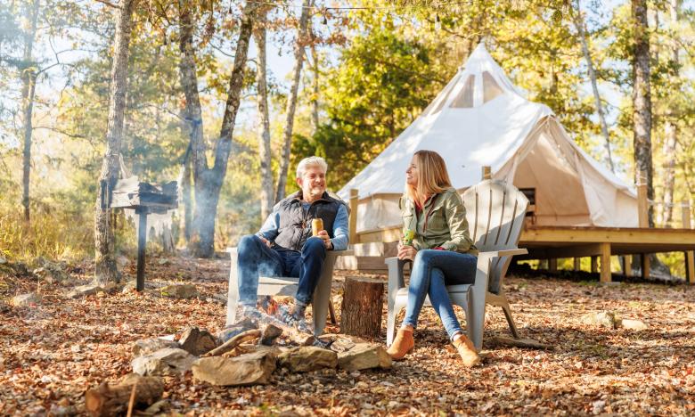 Couple sitting outside a tent at Ouachita Wilde