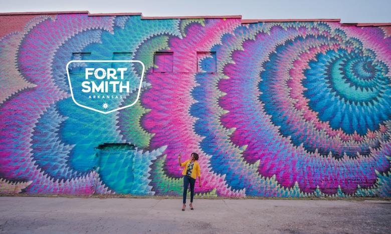 Vibrant pink and blue mural in Fort Smith