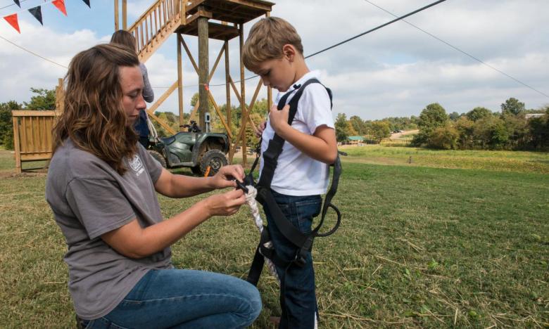 A child on the zip line at Pumpkin Hollow