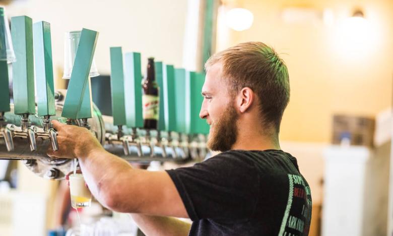 Get a pint from one of the 18 rotating taps at Superior Bathhouse Brewery