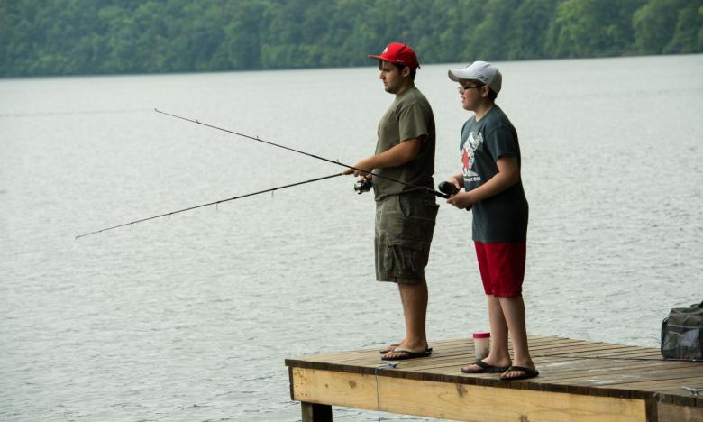 Boys fish from a pier at Lake Catherine