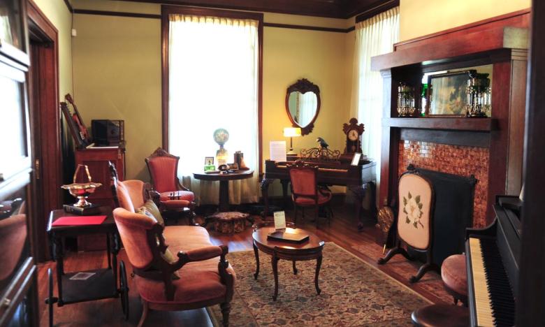 Inside the South Arkansas Heritage Museum. The front room contains items like a rose velvet mahogany set from Louis Gene's and a lamp that was owned by the grandmother of former Arkansas governor Sid McMath.