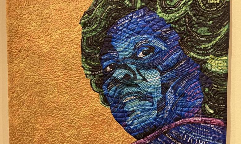This quilt, called Mrs. Hamer, features Fannie Lou Hamer who was a civil rights activist for voting rights.