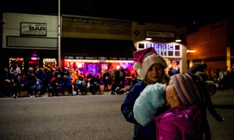 Young girls enjoy cotton candy at Springdale's Christmas Parade.