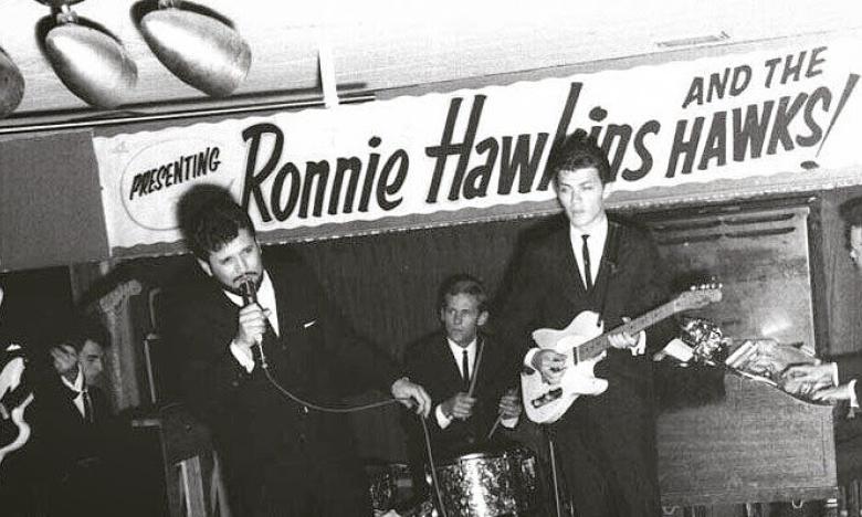 Levon began playing for Ronnie Hawkins, also an Arkansas native, after graduating high school.