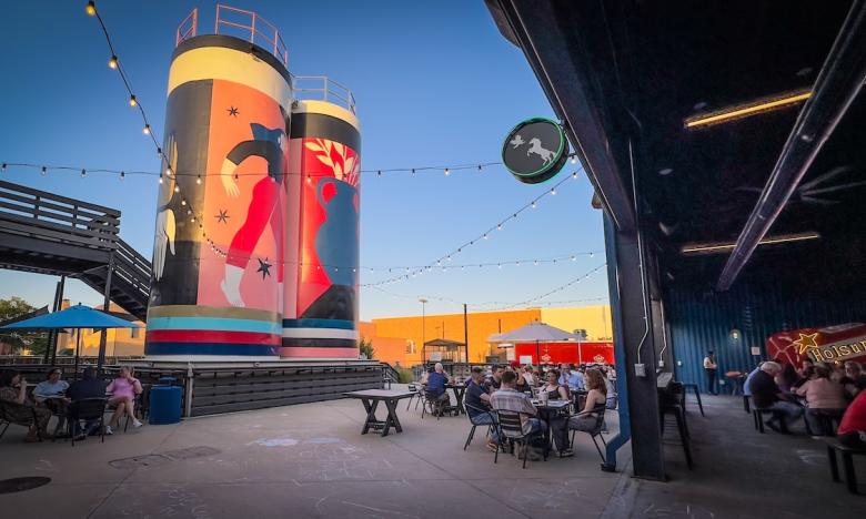 restaurant patio with silos and murals