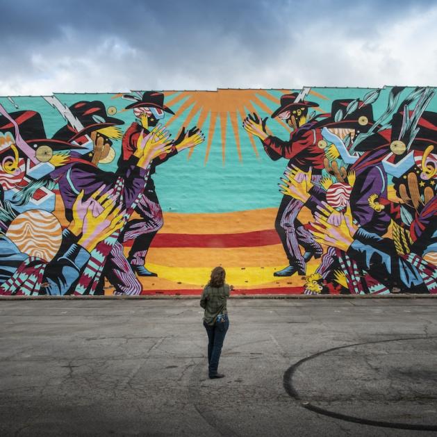 Colorful mural of cowboys