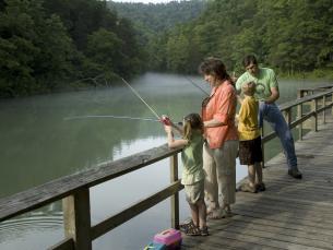 A family fishing from the pier on Mirror Lake in Arkansas