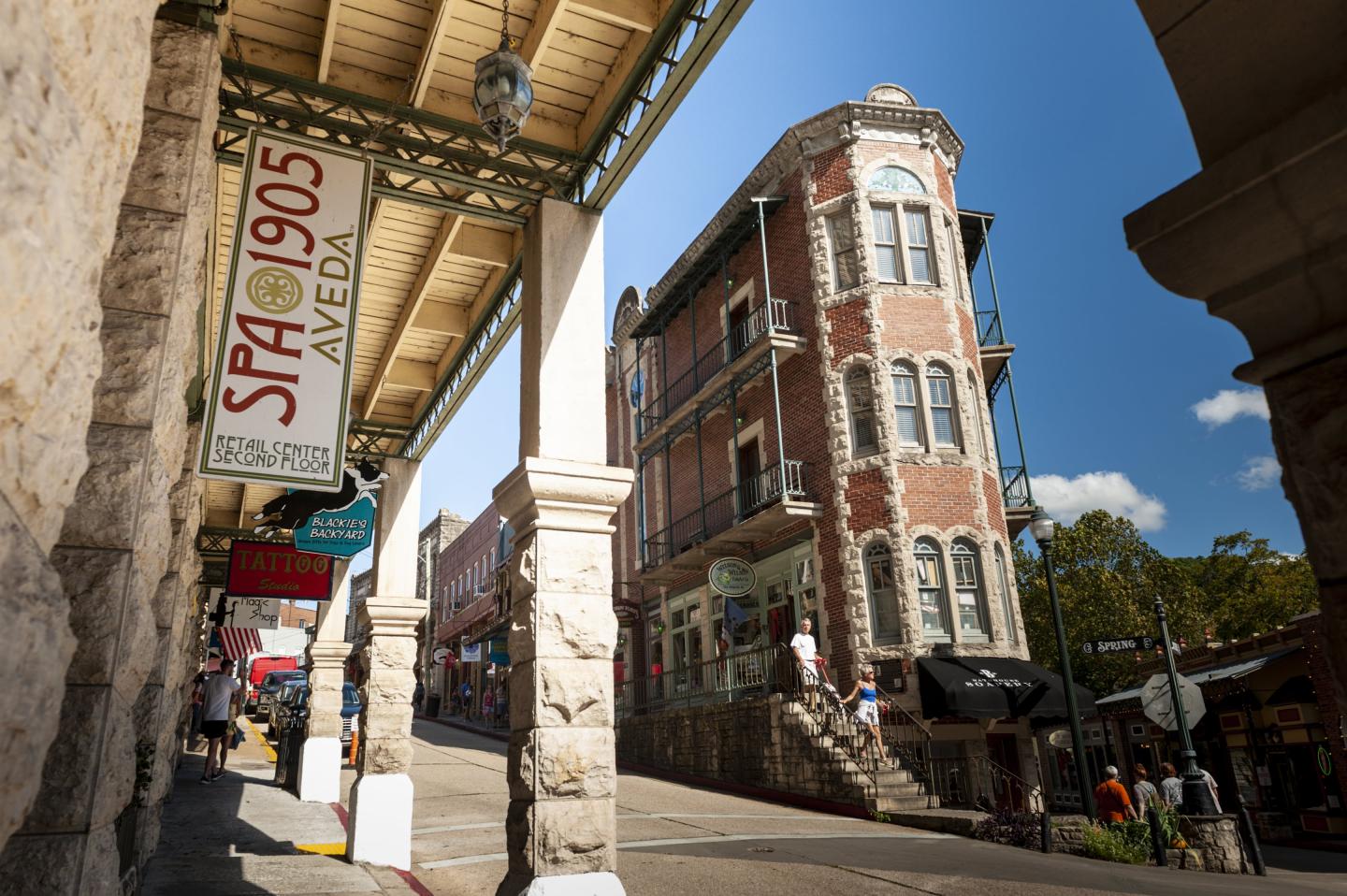 Historic brick building on a sunny street corner under a blue sky.