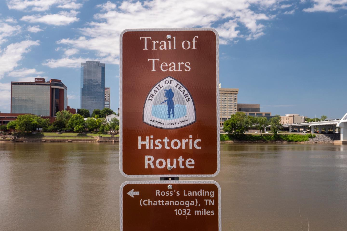 Trail of Tears historic route sign, cityscape in background.