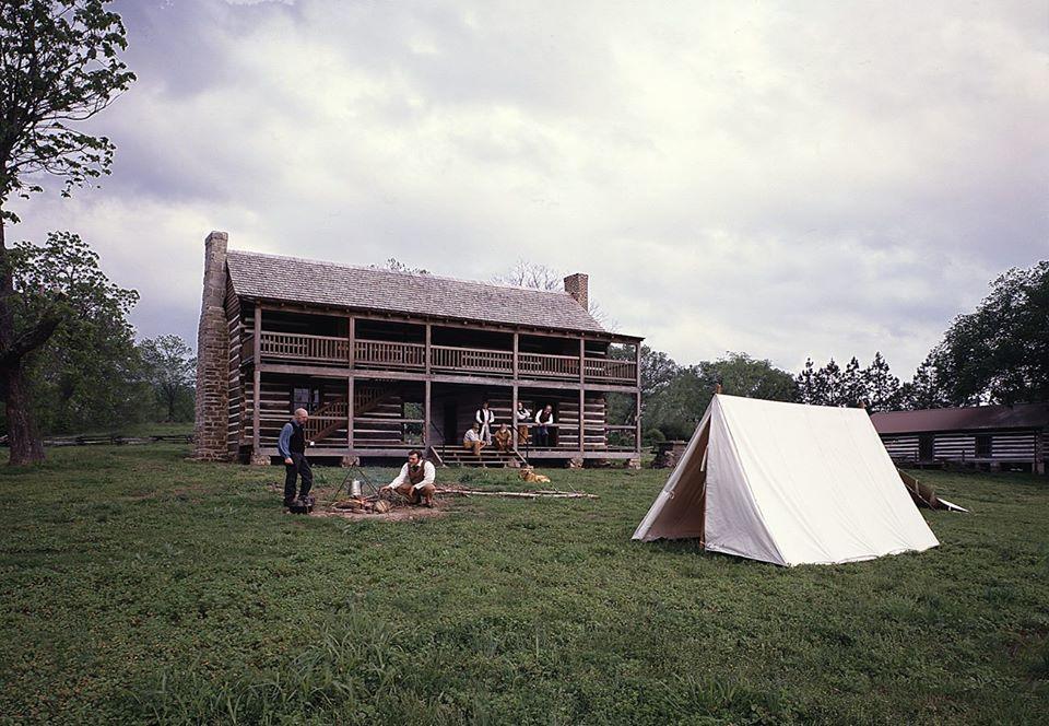 Jacob Wolf House pictured from a distance with a white tent in front.