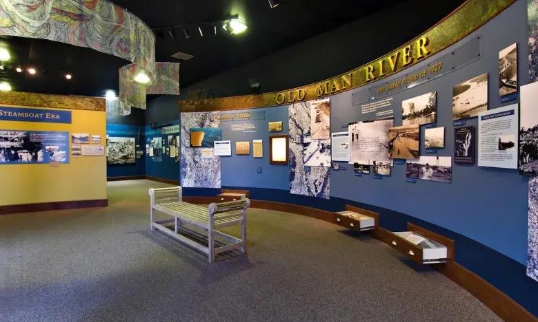 Museum exhibit room with blue walls and informational displays.