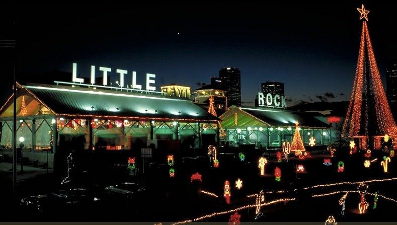 Festive holiday lights with "Little Rock" sign at night.
