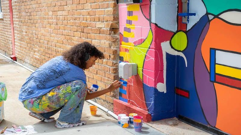 Visiting artist and intern Amanei Johnson created a mural on our new space, ART WORKS on Main, as part of her artist in residency at the Arts &amp;amp; Science Center.