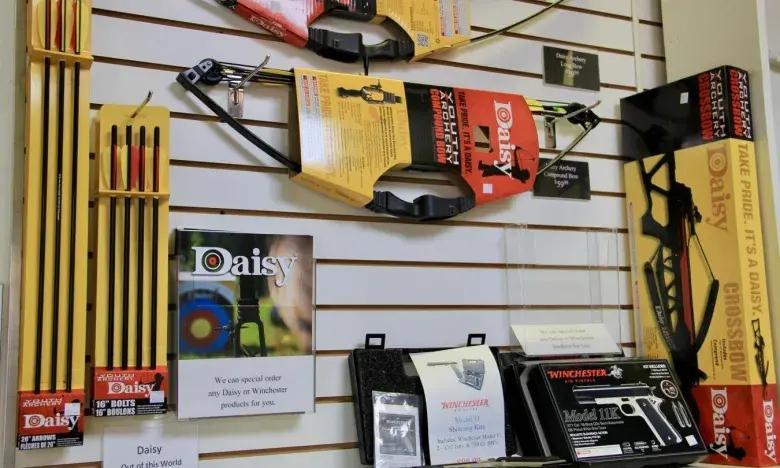 Archery supplies displayed on a slat wall in a store.