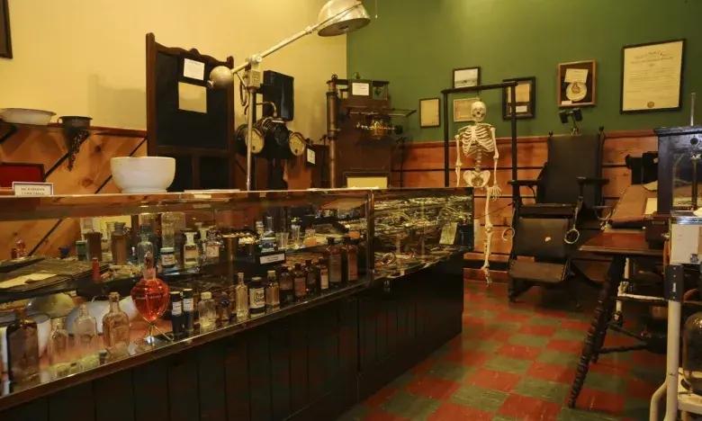 Vintage medical office with glass cabinets, skeleton model, and wooden decor.